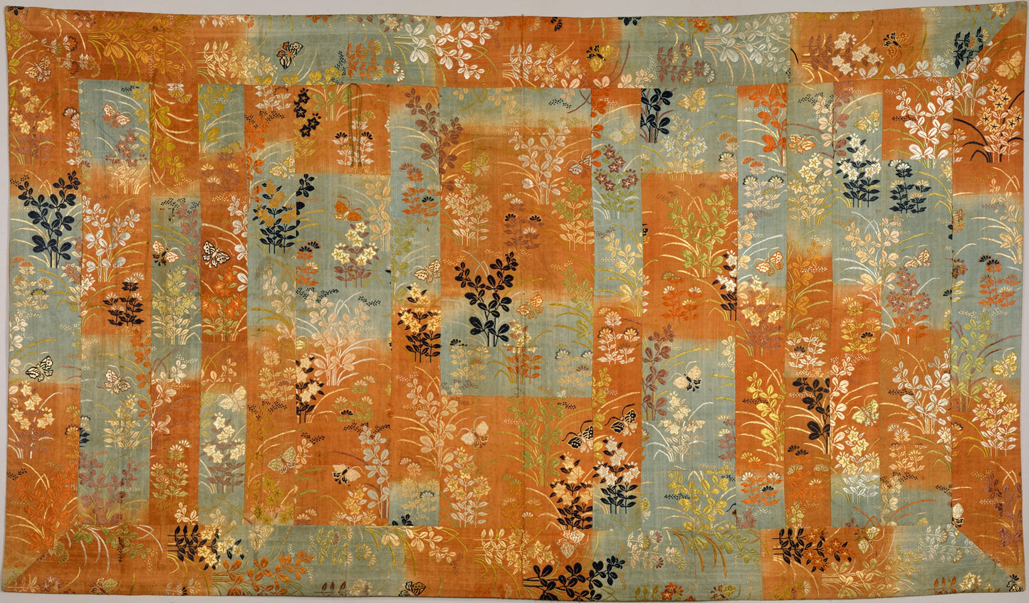 Decorative rug with a floral pattern on an orange and blue background
