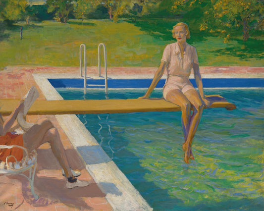 Woman sitting by a pool with a garden in the background