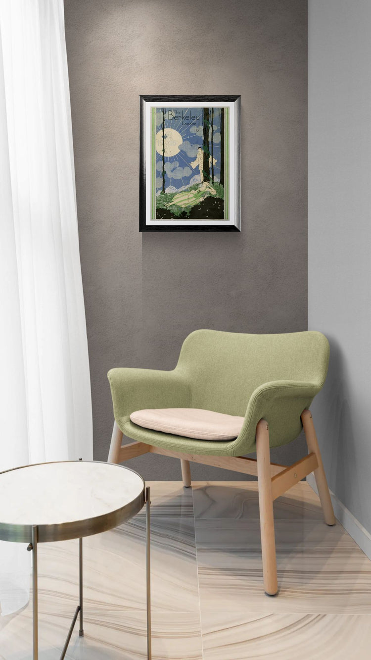Green chair with beige cushion in a room with a framed artwork on the wall.