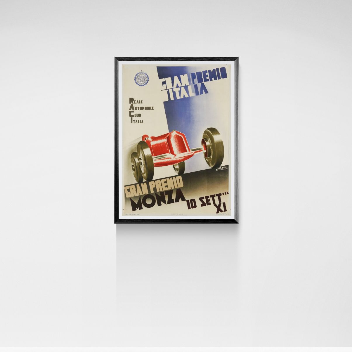 Framed vintage race car poster on a white wall