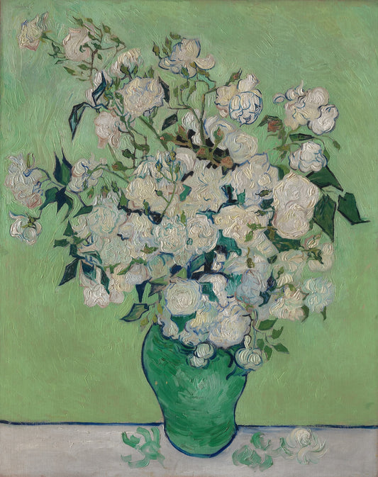 Bouquet of white flowers in a green vase on a light green background
