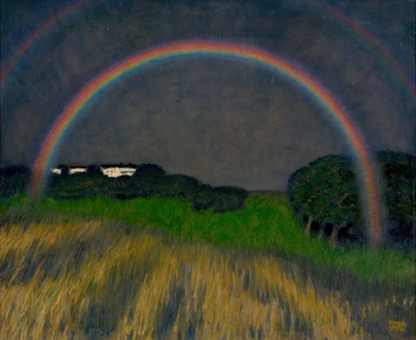 Rainbow over a field with trees at night