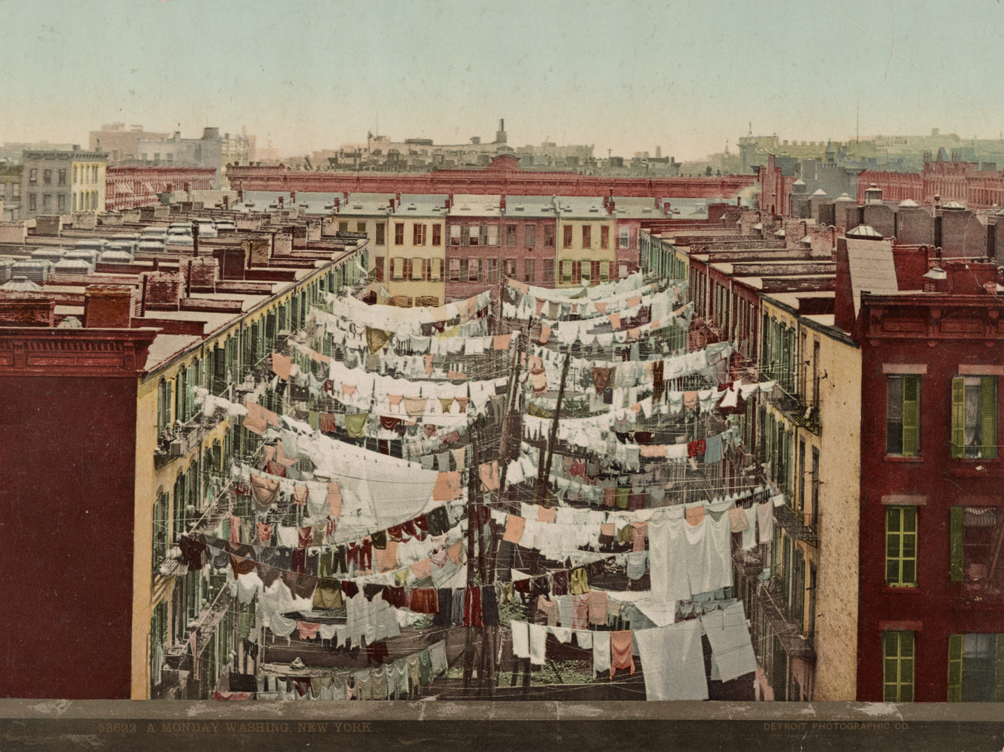 Vintage photograph of clothesline with laundry on rooftops of urban buildings