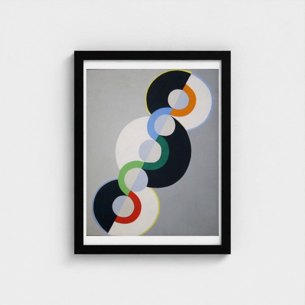 Framed abstract art with colorful circular design on a gray background