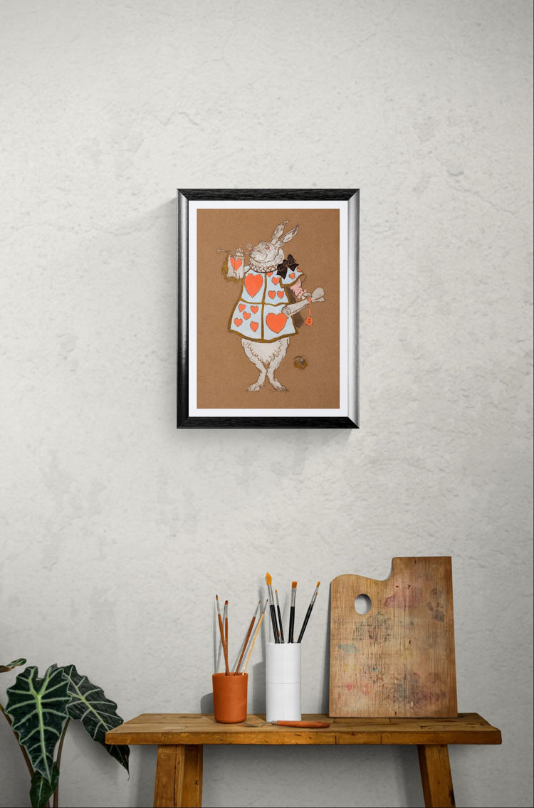 Framed artwork of a rabbit in a suit on a textured wall above a wooden table with art supplies.