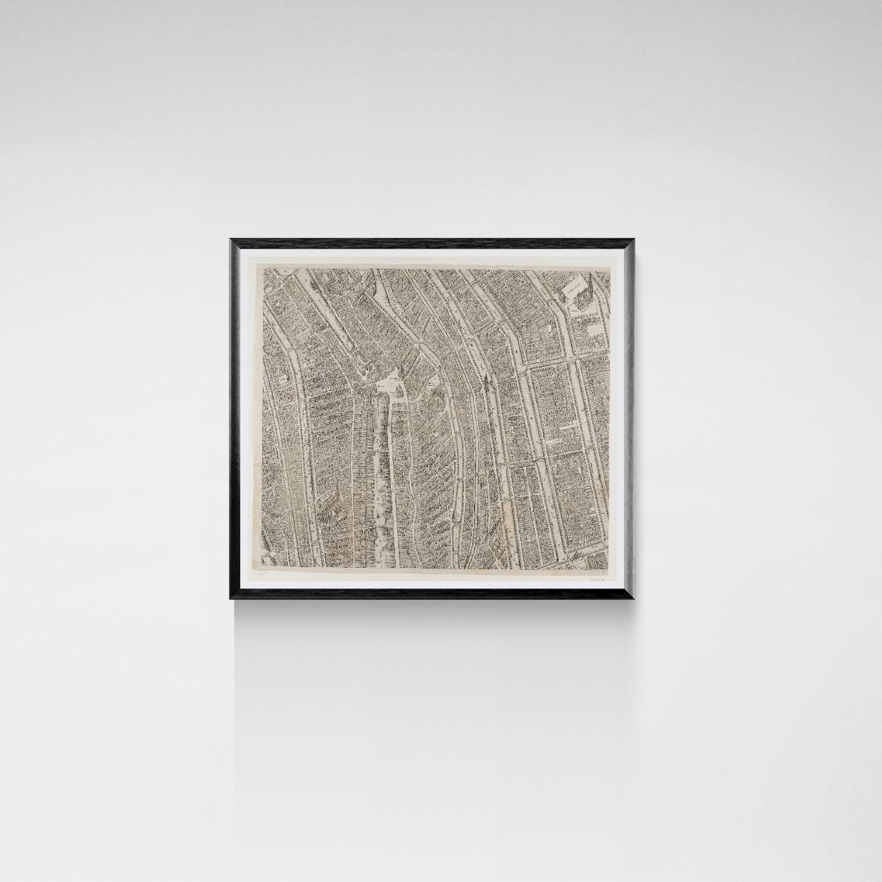 Framed Amsterdam map print on a white wall