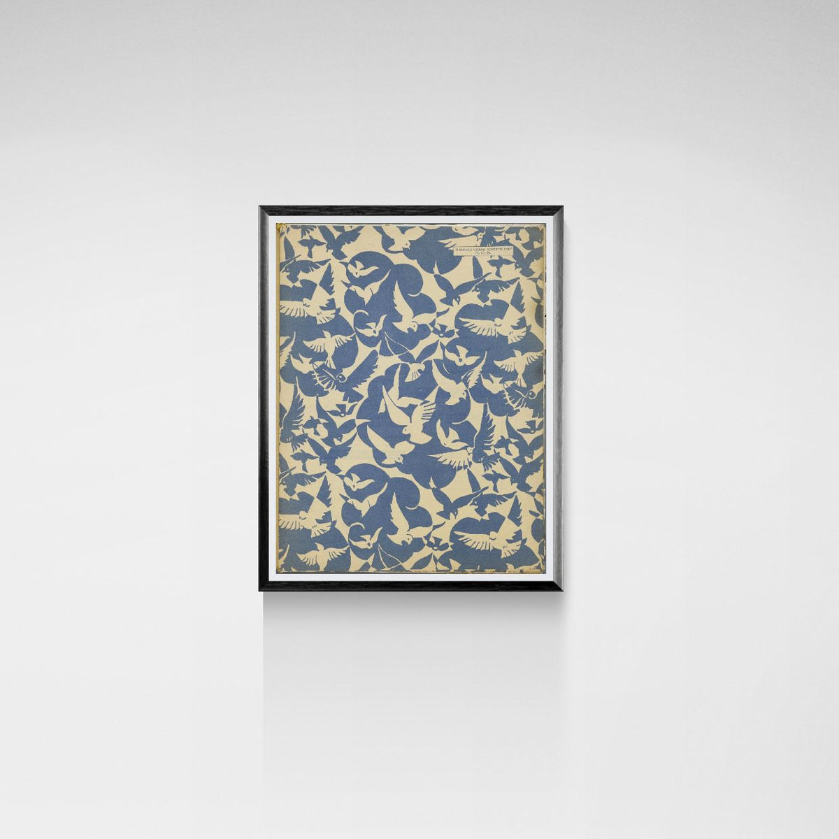 Framed artwork with a pattern of birds on a white wall