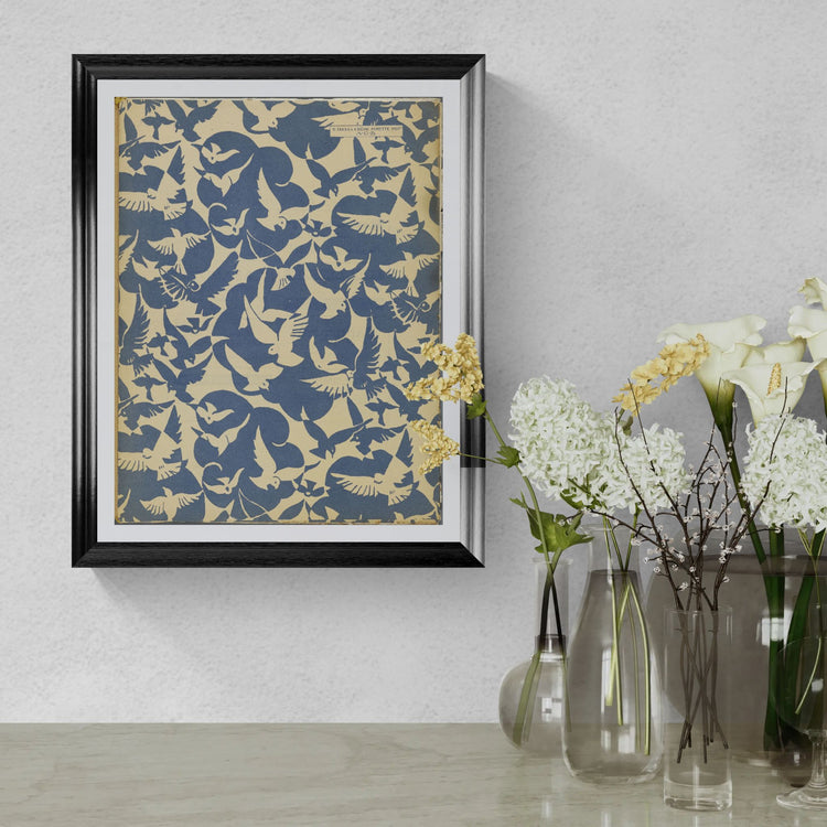 Framed abstract art piece on a wall with decorative vases and flowers below.