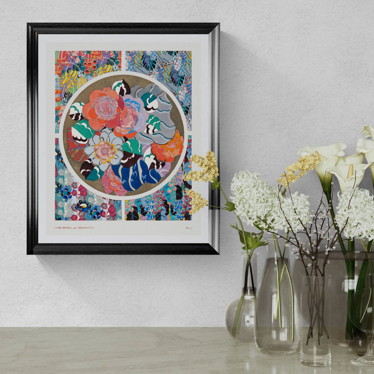 Framed colorful artwork with floral and animal design on a wall above a table with vases.