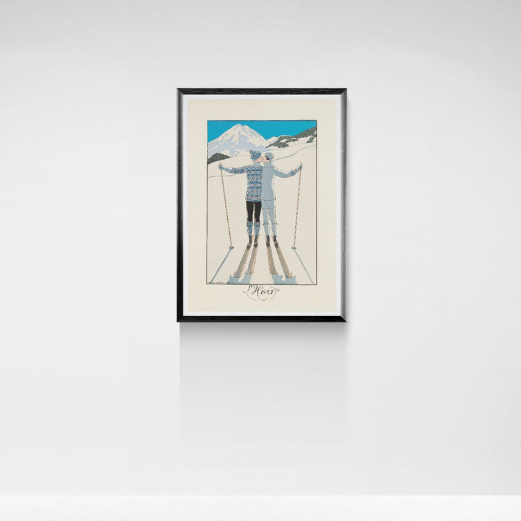 Framed artwork of two skiers embracing with a mountain backdrop on a white wall.