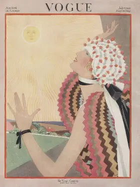 Vintage Vogue magazine cover with a woman in a colorful dress and headscarf against a sunlit sky.