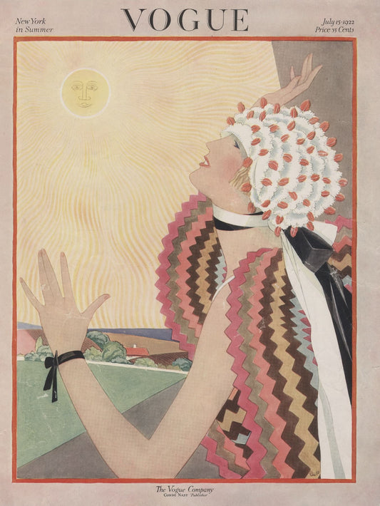 Vintage Vogue magazine cover with a woman in a colorful dress and headscarf against a sunlit sky.