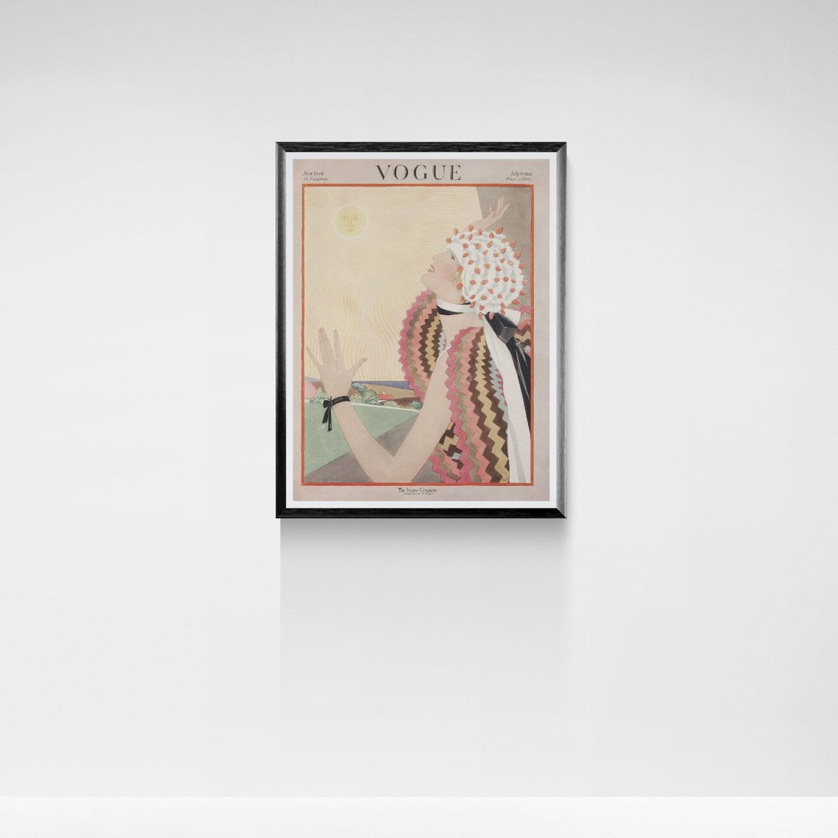 Framed Vogue magazine cover on a white wall