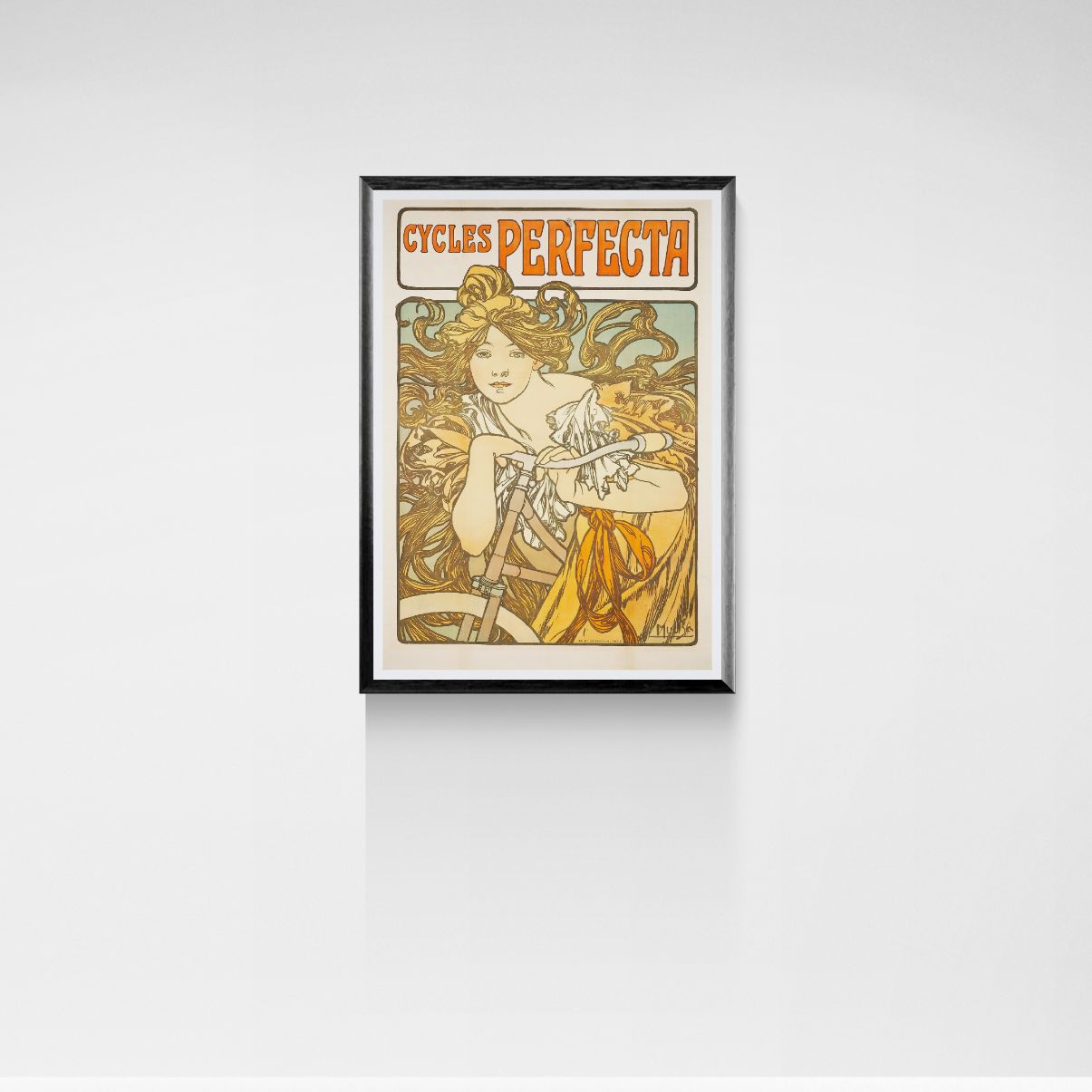 Framed vintage-style poster of a woman with 'Cycles Perfecta' text on a white wall.