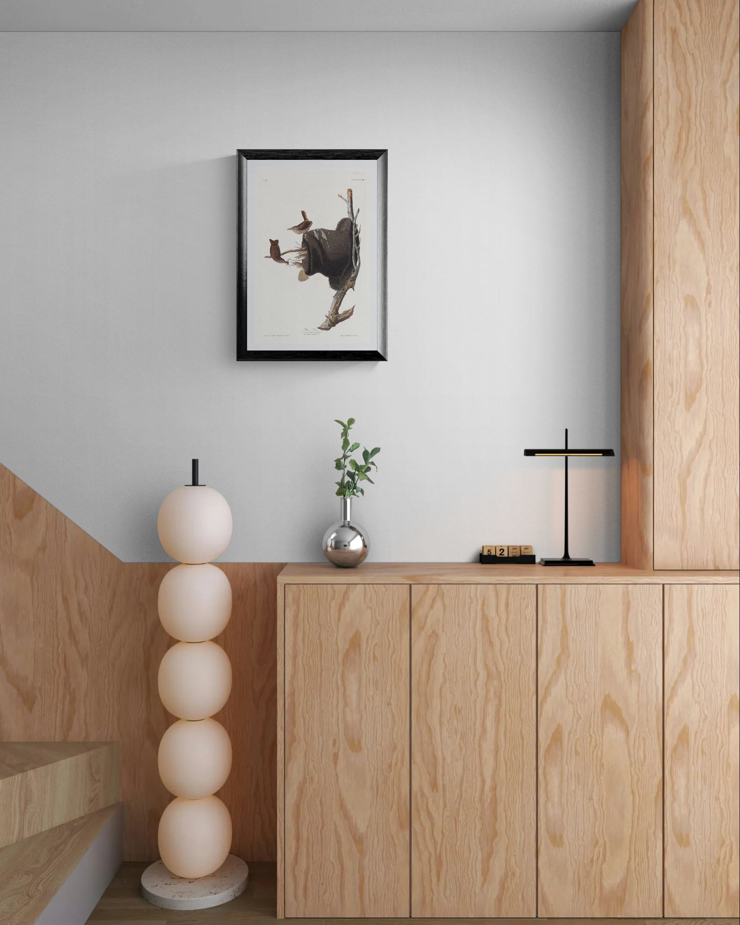 Modern interior with wooden cabinets, decorative lamps, and a framed picture on the wall.
