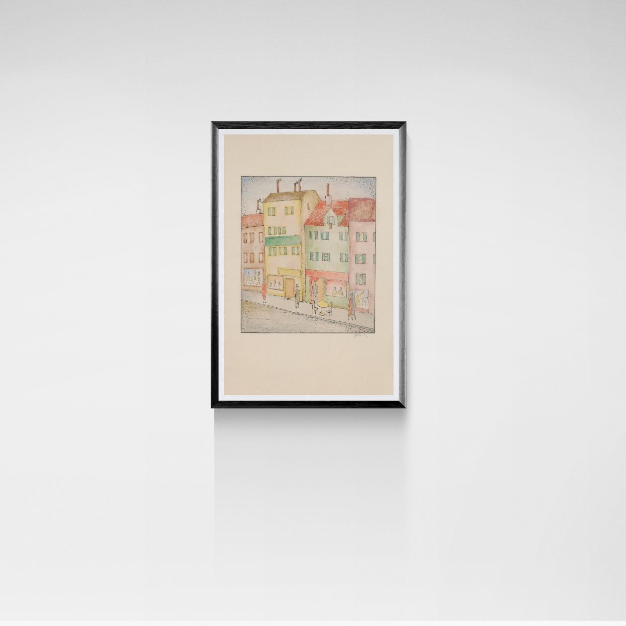Framed artwork of a colorful building on a white wall