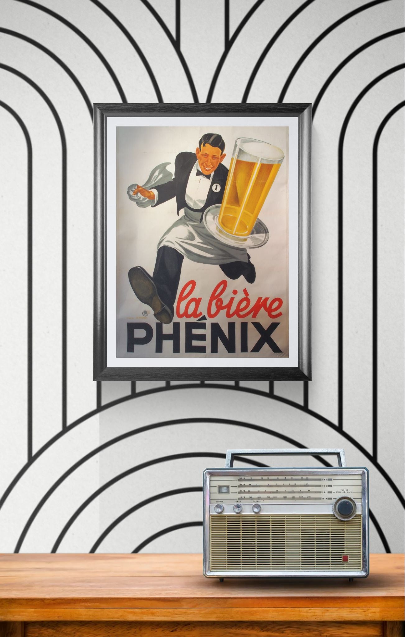 Framed vintage beer advertisement on a wall with a retro radio below.
