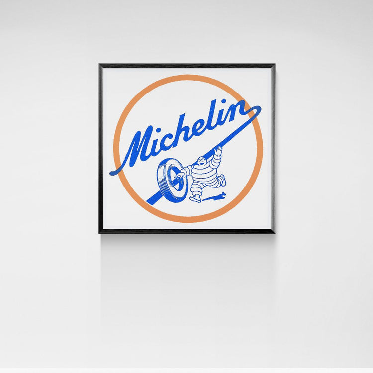 Framed Michelin logo with a character on a white wall