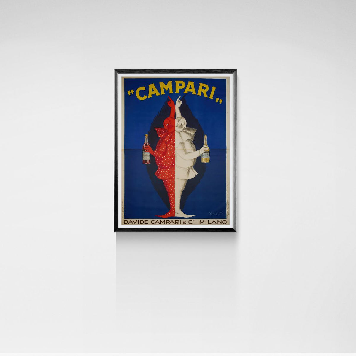 Framed Campari print advertisement on a white wall