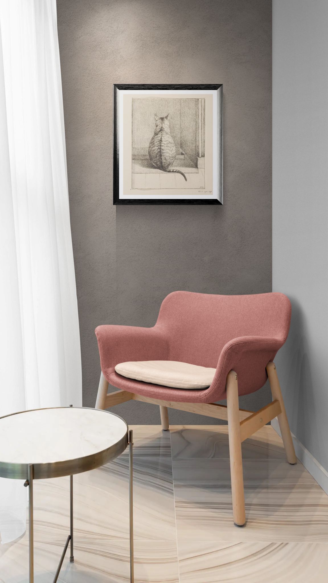 Pink armchair with a beige cushion in a room with a gray wall and framed picture.