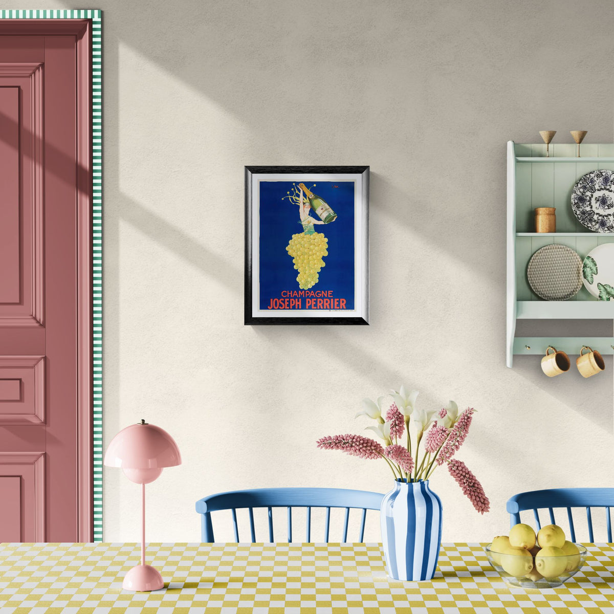 Dining room with a framed poster on the wall, pink lamp, blue chairs, and a checkered tablecloth.