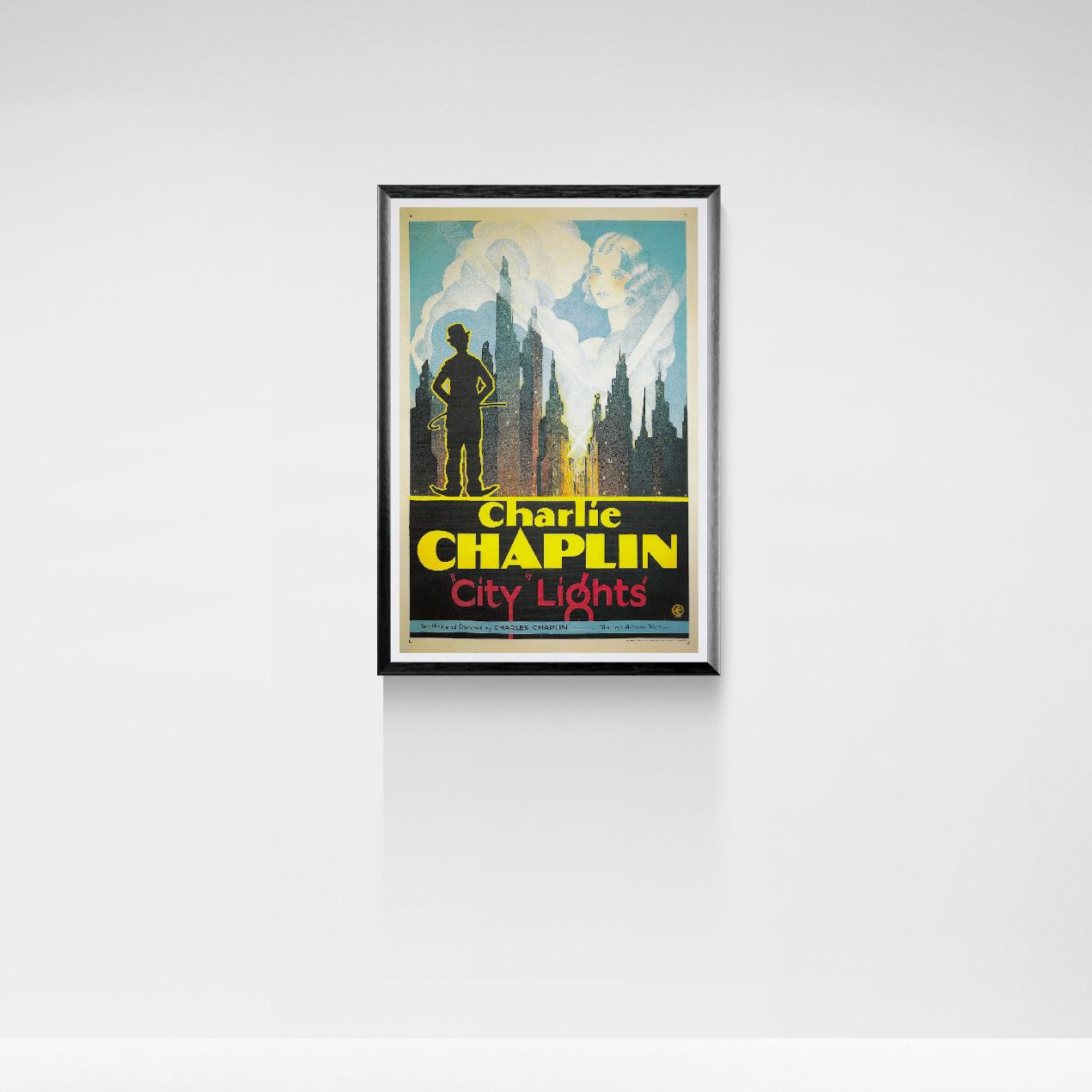 Framed poster of Charlie Chaplin's 'City Lights' on a white wall