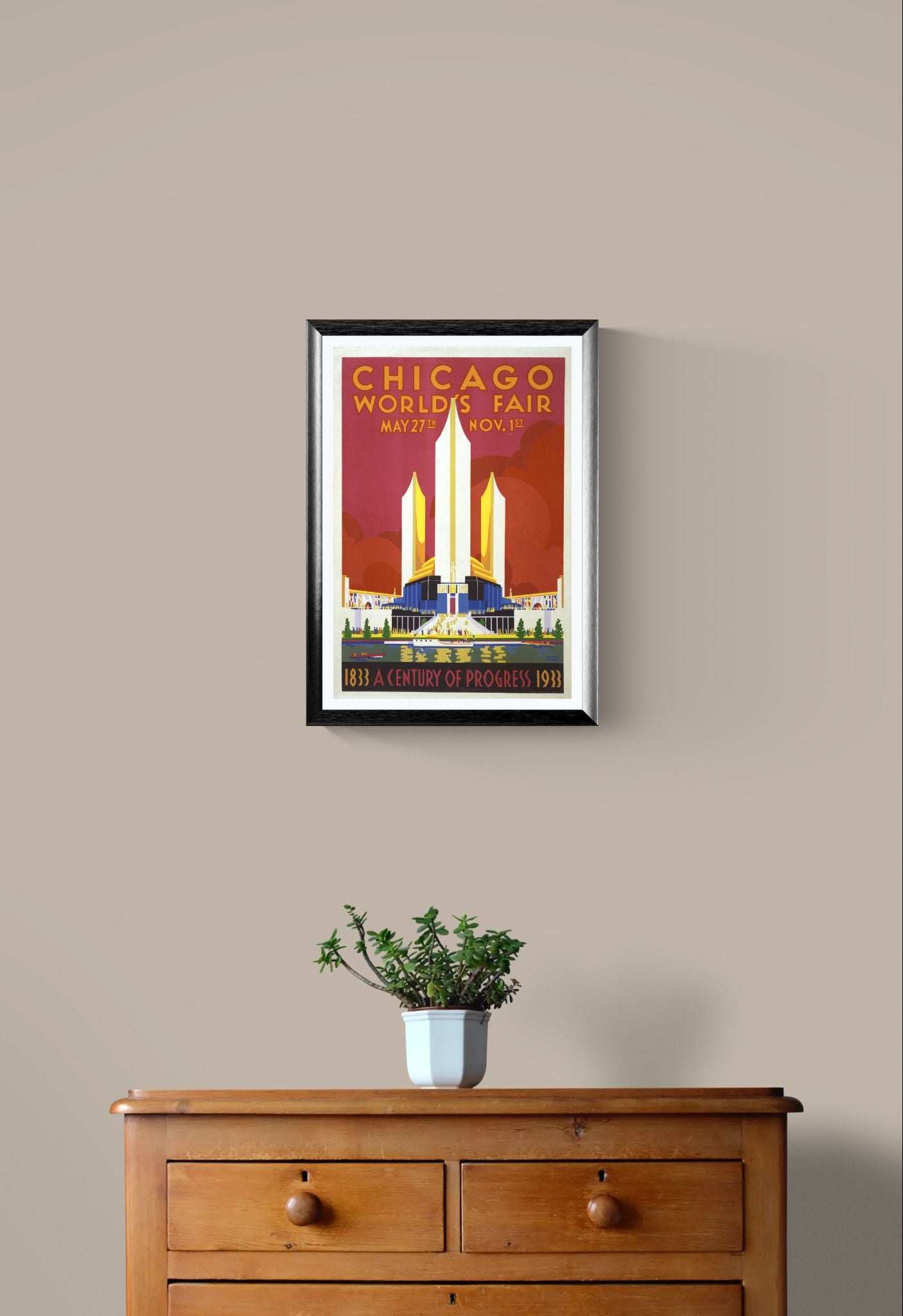 Framed poster of the Chicago World's Fair on a wall above a wooden dresser with a plant.