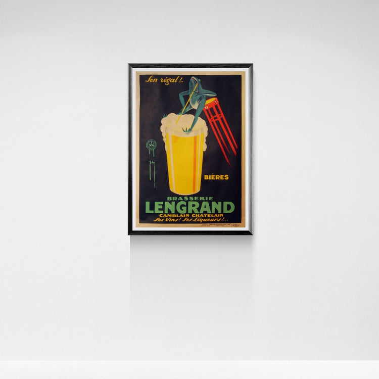 Framed vintage-style beer advertisement poster on a white wall