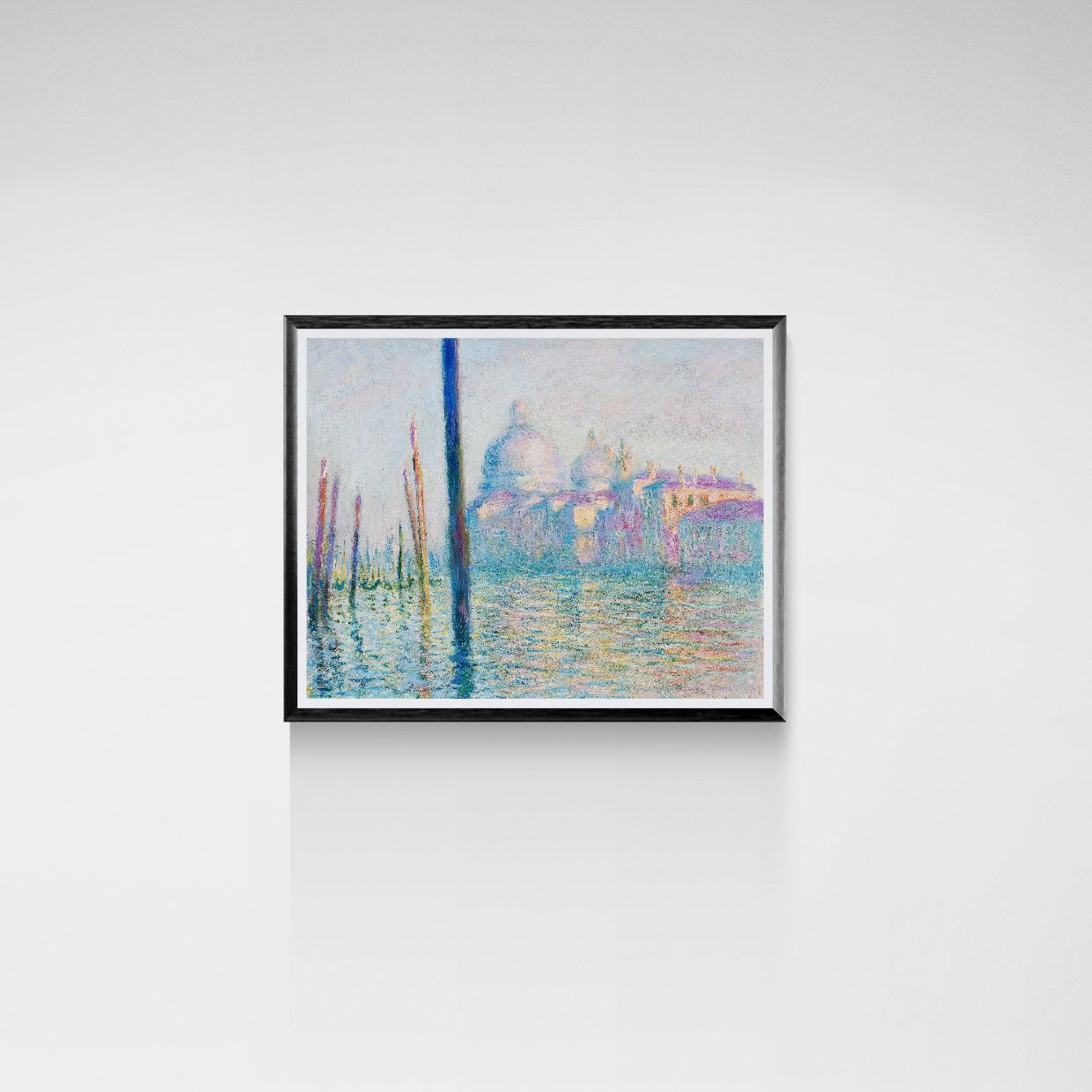 Framed artwork of a cityscape with water on a white wall