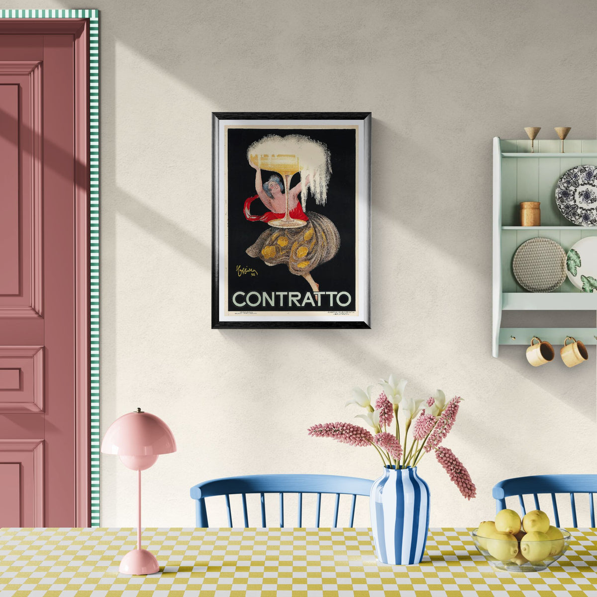 Framed artwork on a wall above a dining table with decor items.