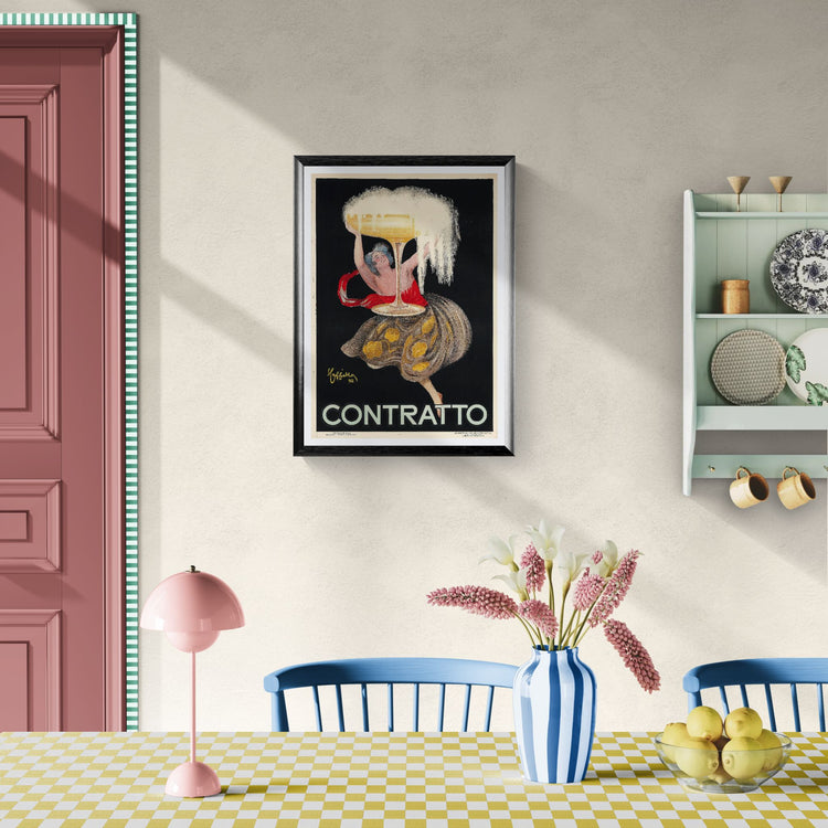 Framed artwork on a wall above a dining table with decor items.