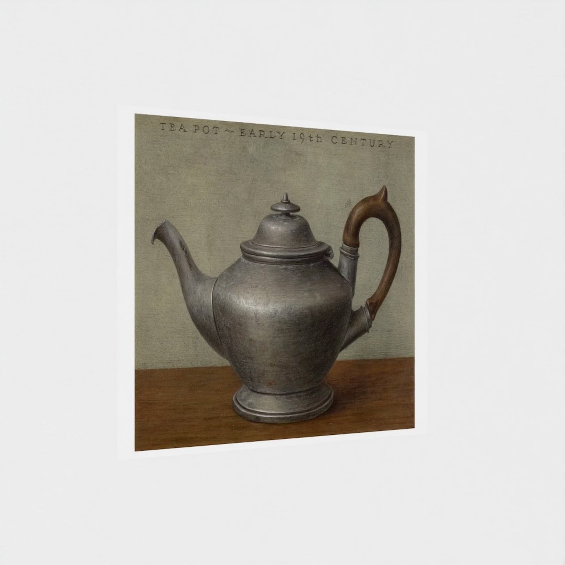 Vintage silver teapot on a wooden surface with a neutral background