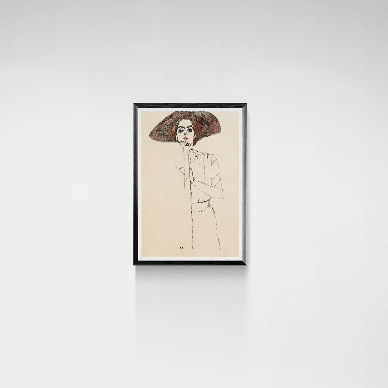 Framed artwork of a woman with a large hat on a white wall