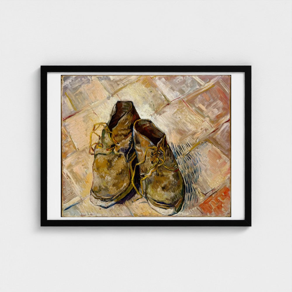 Framed artwork of two brown shoes on a textured surface