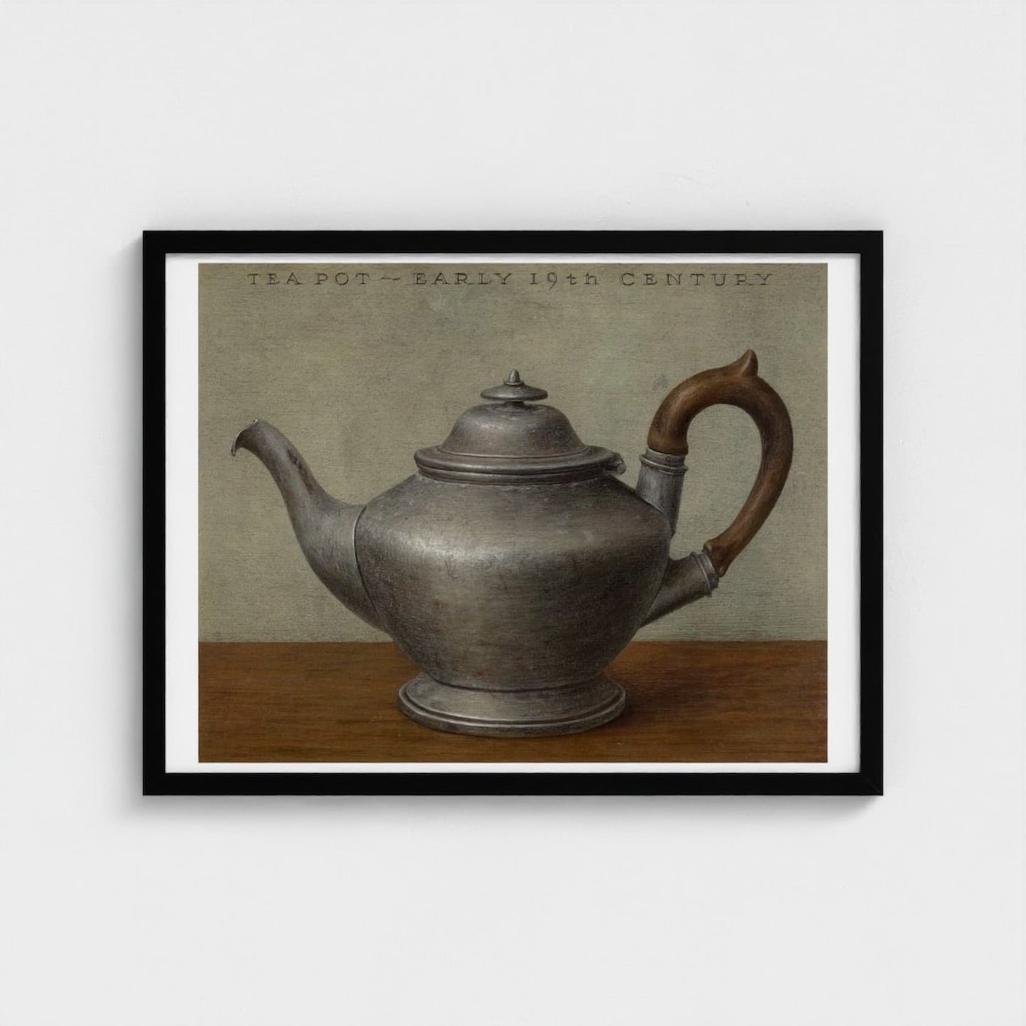 Framed artwork of an early 19th century teapot on a wooden surface with a neutral background.