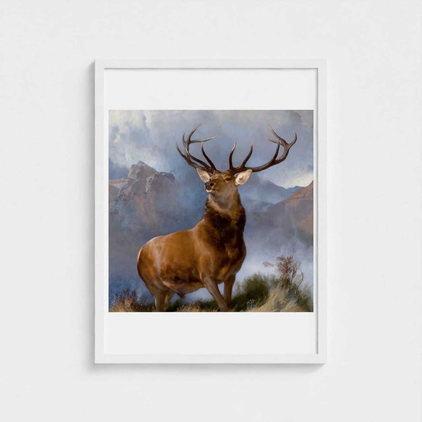 Framed painting of a deer with mountains in the background