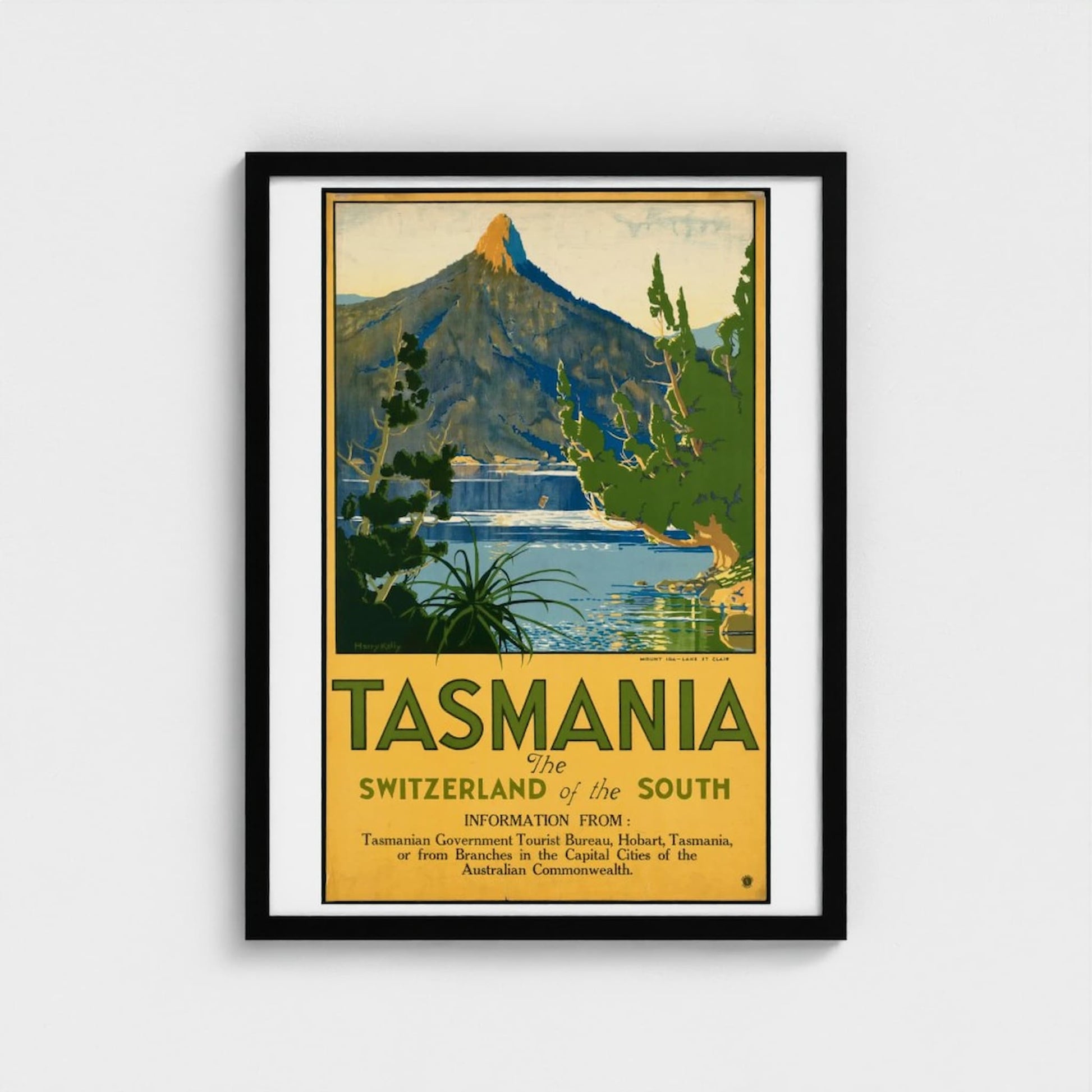 Framed travel poster for Tasmania featuring a mountain and lake.