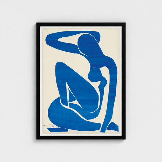 Framed artwork of a blue silhouette of a seated figure on a beige background
