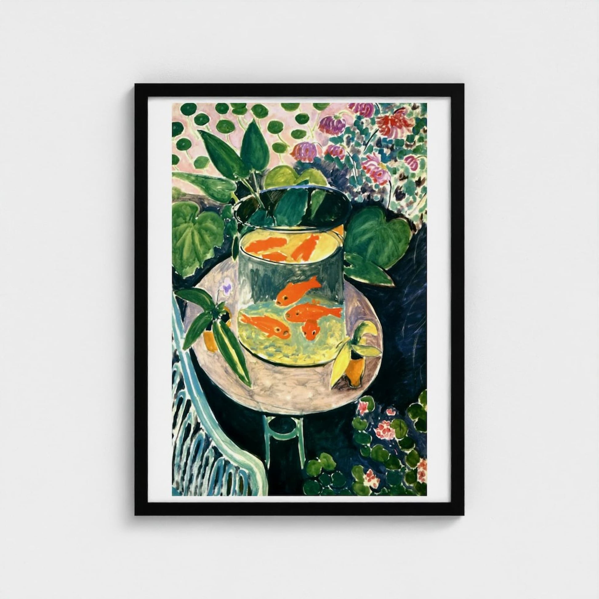 Framed artwork of a still life with goldfish in a bowl, plants, and flowers on a polka dot tablecloth.