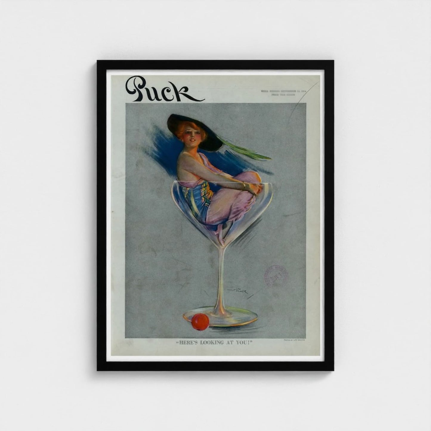 Framed vintage magazine cover of 'Puck' with a woman in a glass