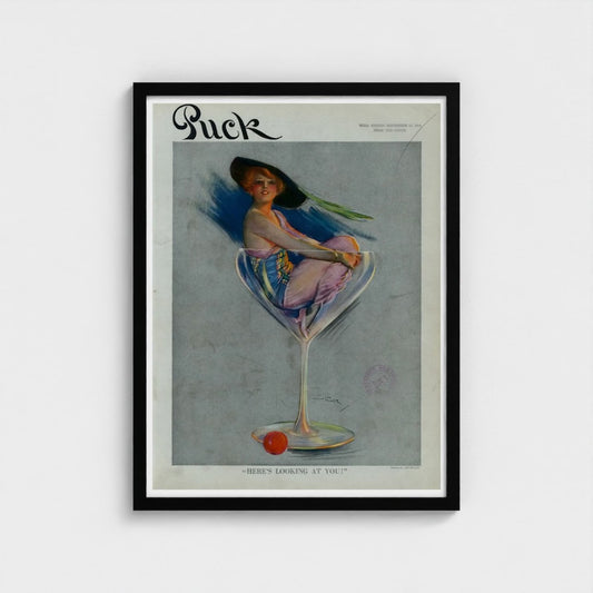 Framed vintage magazine cover of 'Puck' with a woman in a glass