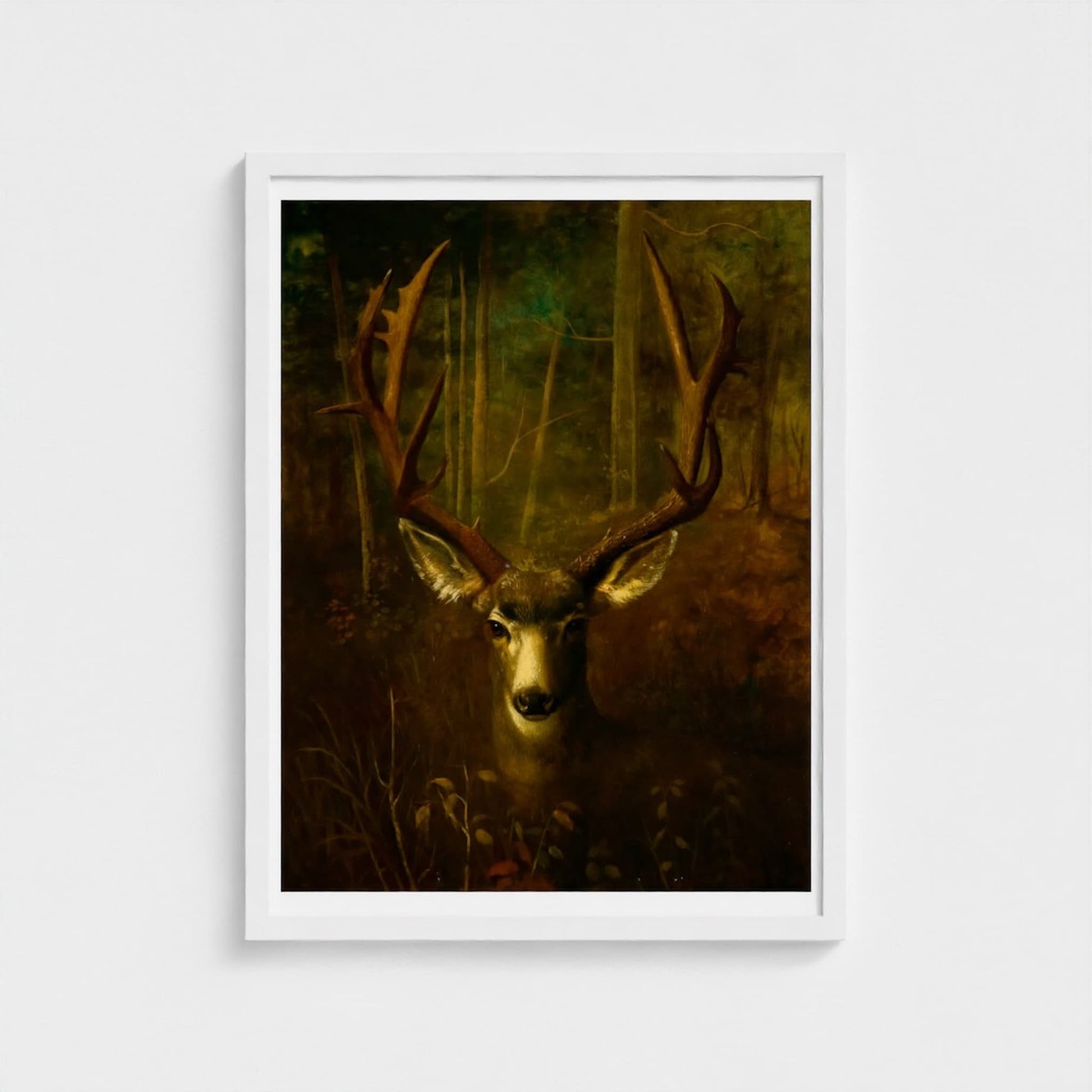 Framed artwork of a deer in a forest setting on a white wall.