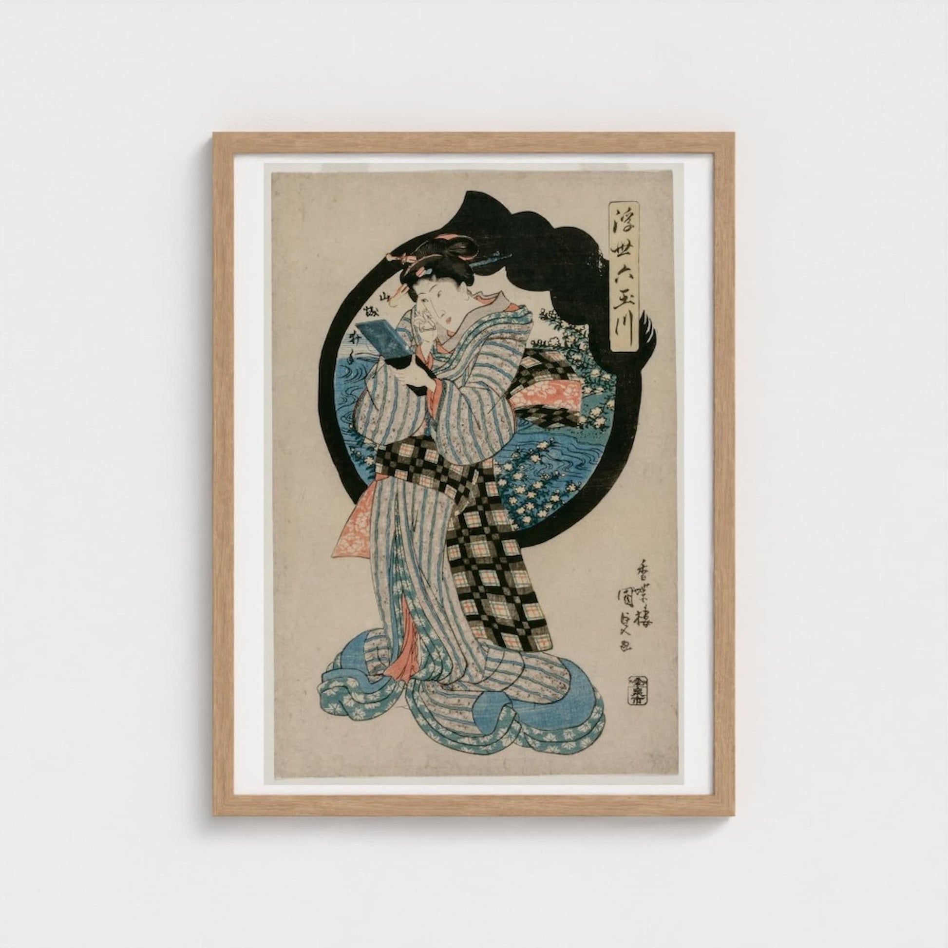 Framed artwork of a traditional Japanese print with a woman in a kimono on a white background