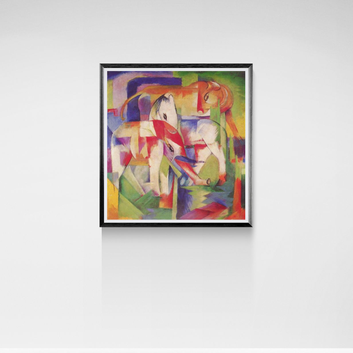 Framed abstract artwork with colorful geometric design on a white wall