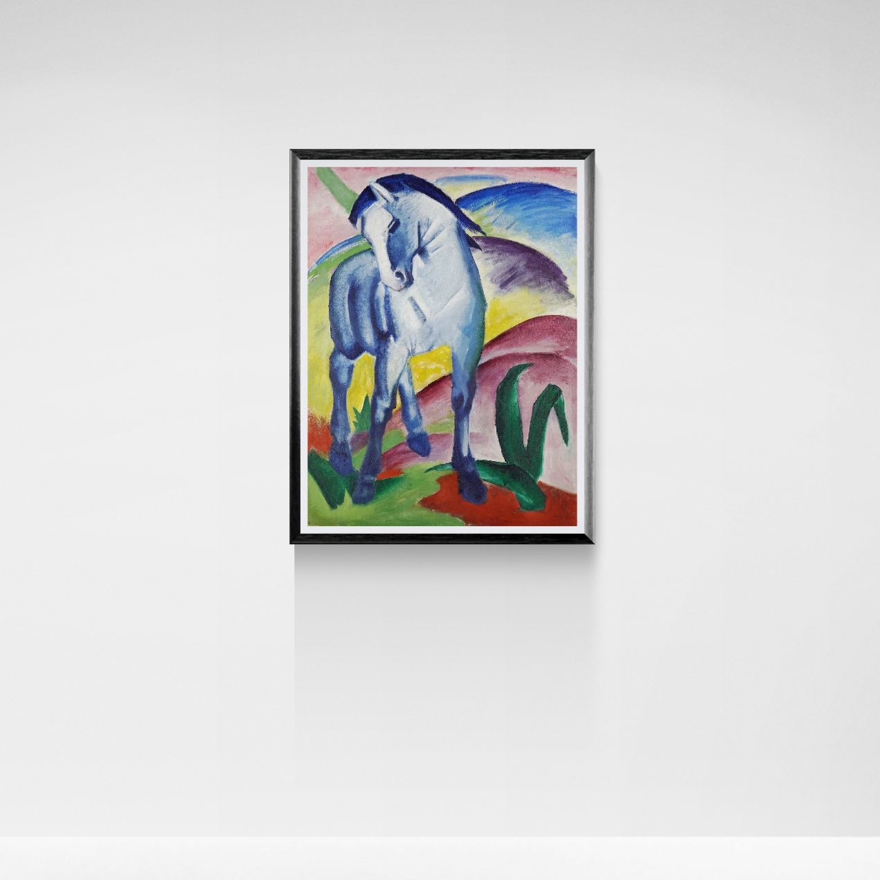 Framed artwork of a horse in a colorful landscape on a white wall