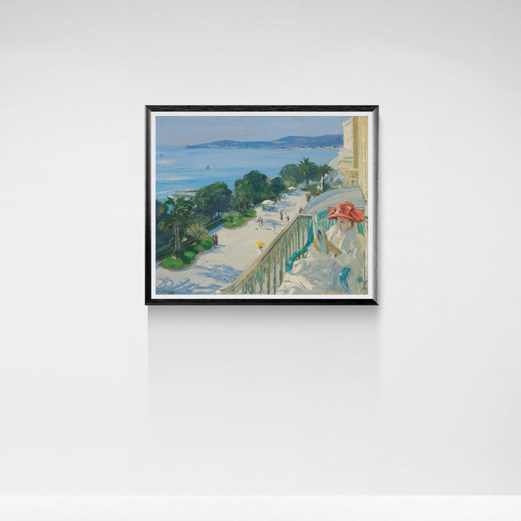 Framed artwork of a coastal scene with a balcony and ocean view on a white wall.