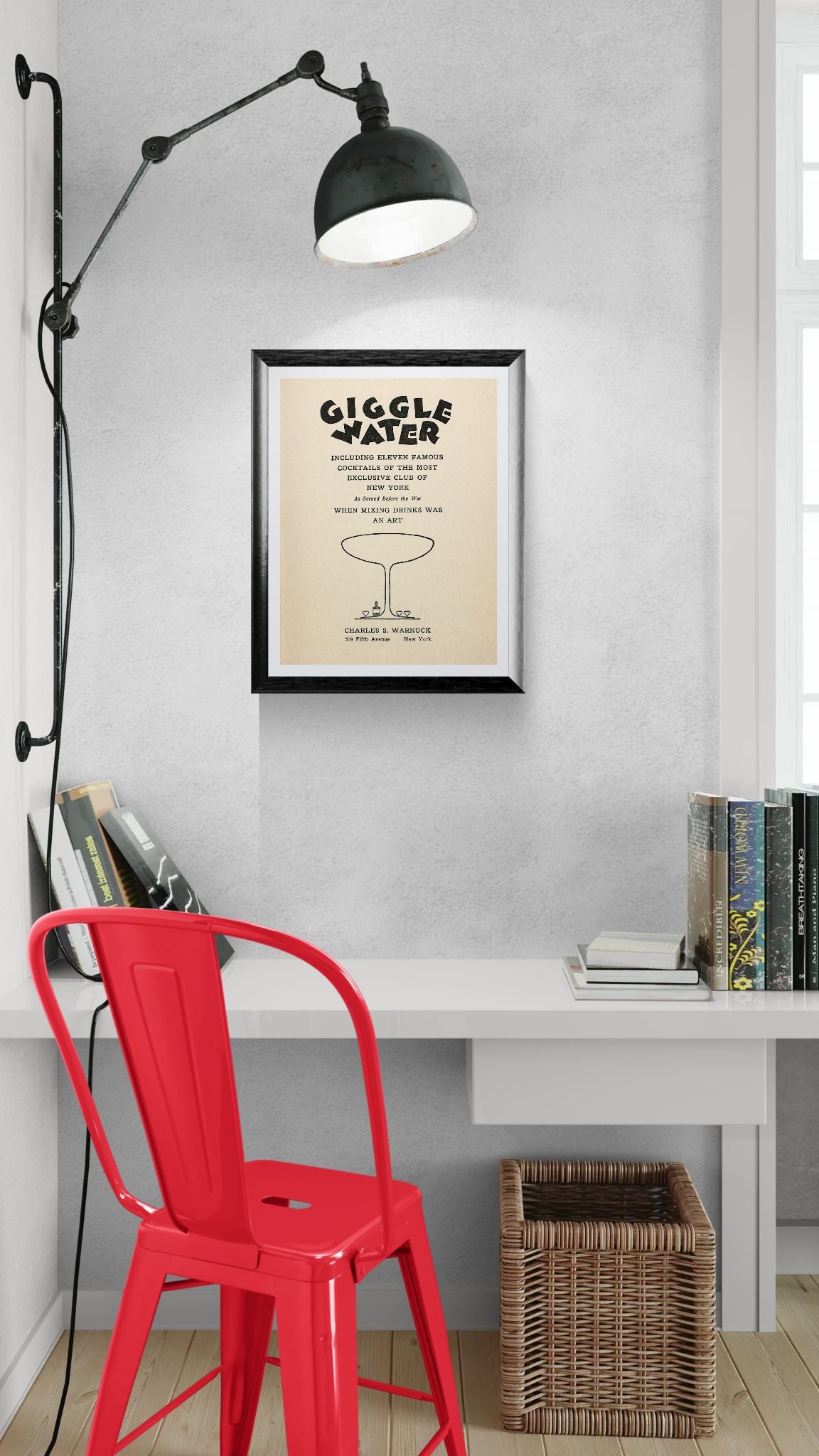 Framed artwork titled 'Giggle Water' on a wall above a desk with a red chair.