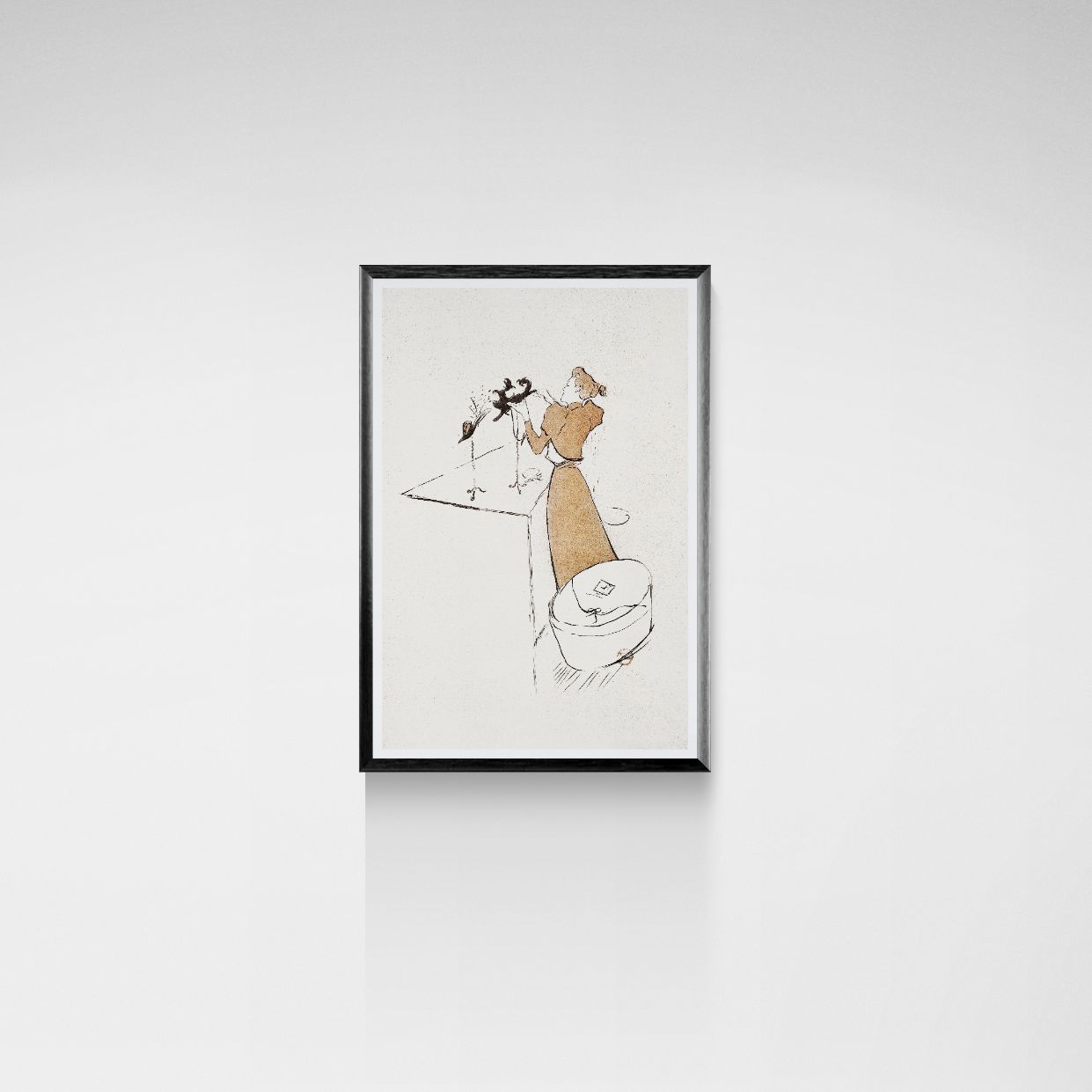 Framed artwork of a stylized figure on a white wall