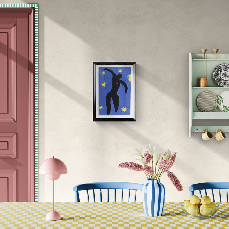 Dining room with a table, chairs, lamp, and wall art.
