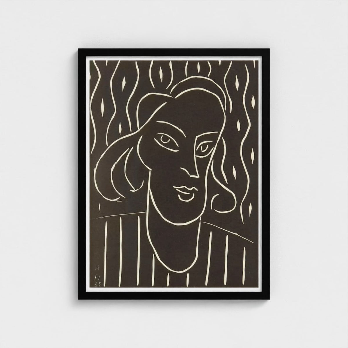 Framed black and white line art of a woman's face on a plain background